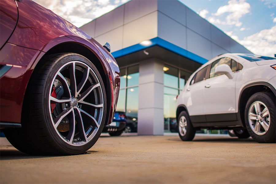 Divirsified Tag and Title Services Maryland Are you a Dealer Page image of cars outside a dealership.