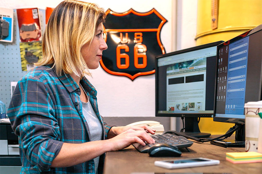 Divirsified Tag and Title Tag Title and Register page image of a woman standing at a computer.